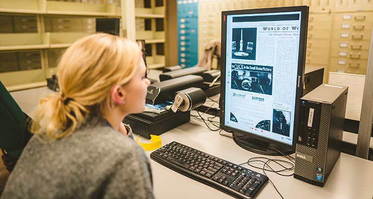 Anna looking at digital renderings of historical documents on a computer