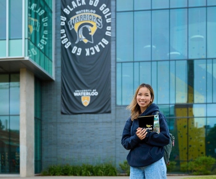 Student holding the Waterloo viewbook