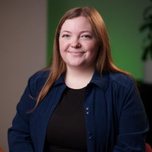 Avery wears a black shirt and blue jacket inside