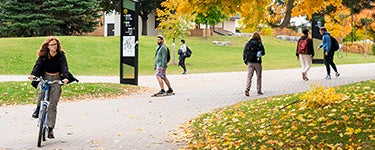 Students walking and cycling on campus