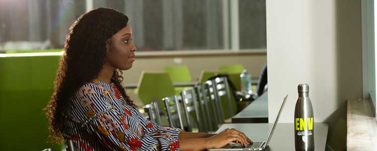 Okeoghene working on a laptop