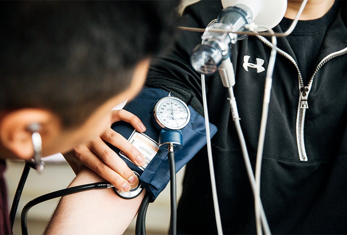 Doctor checking a patients blood pressure