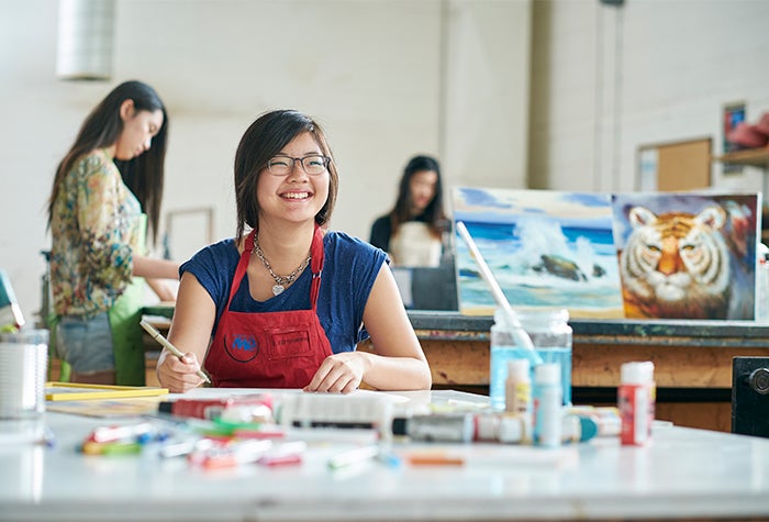 student smiling in art room