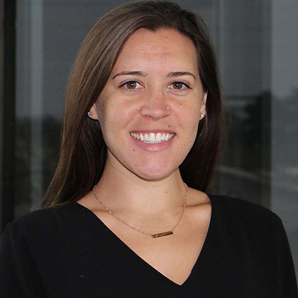 Clare Stevens has long brown hair and wears a black shirt