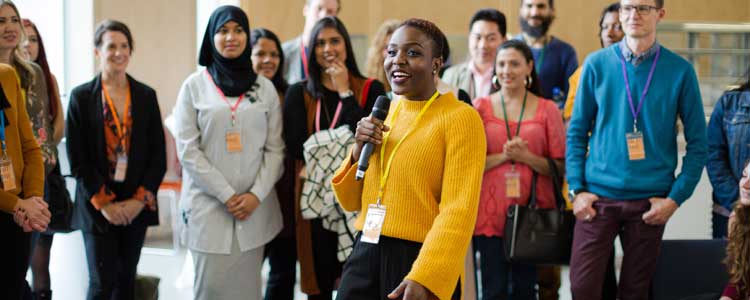 Communications student holding a microphone