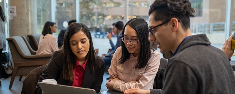 Waterloo co-op students looking at a laptop.