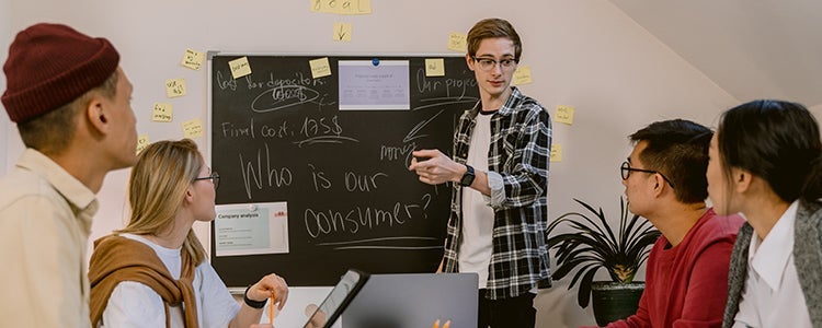 Group of students working together at a blackboard