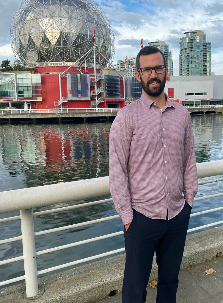 Derek standing next to the Science World in vancouver