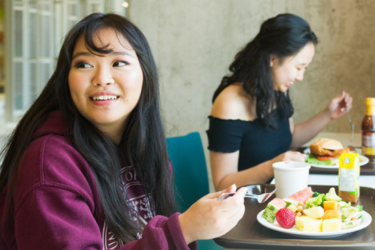 Waterloo student eating on campus.