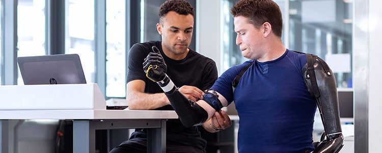 Engineering  strapping robotic arms onto another person