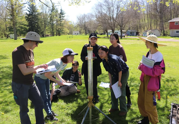 Students conduct field sampling in a field