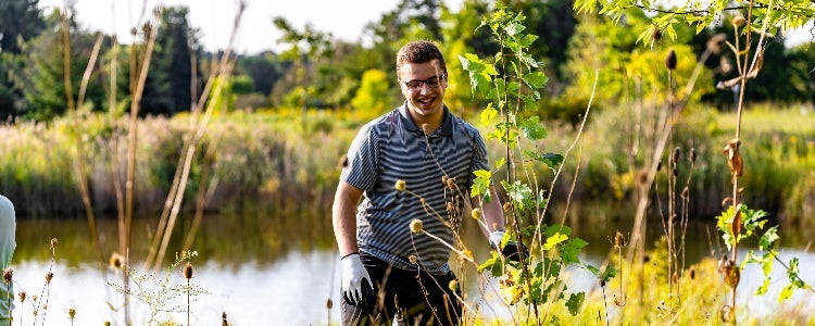 Ethan, a BSFM student working in a field