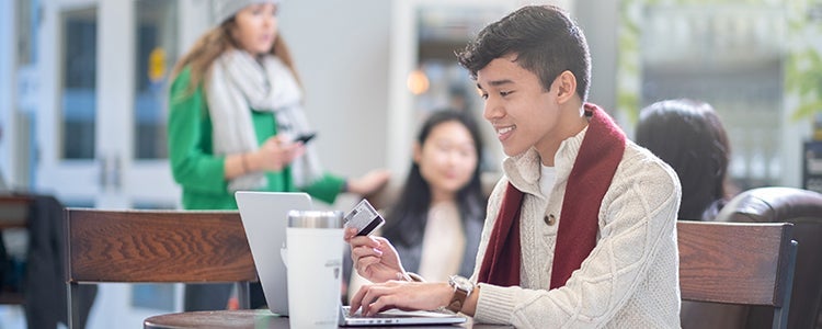 Student typing on a laptop