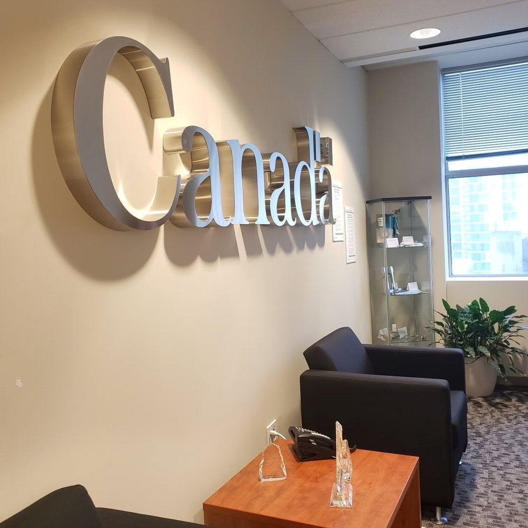 Canada plaque on a wall.