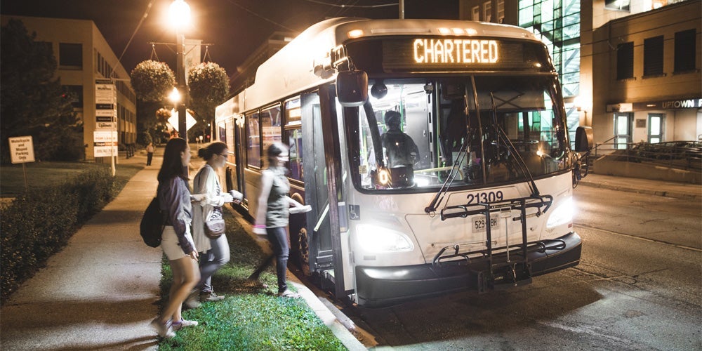 Students getting on a city bus.