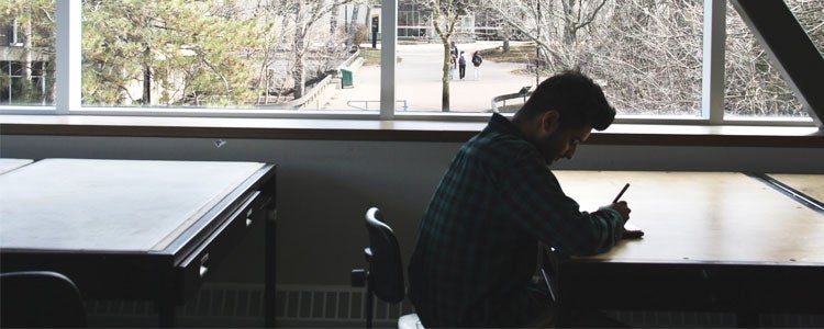 Hafeez sitting at a desk in the Planning studio