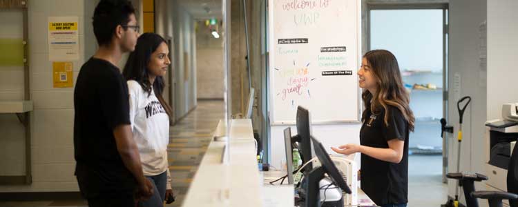 students talking to front desk residence