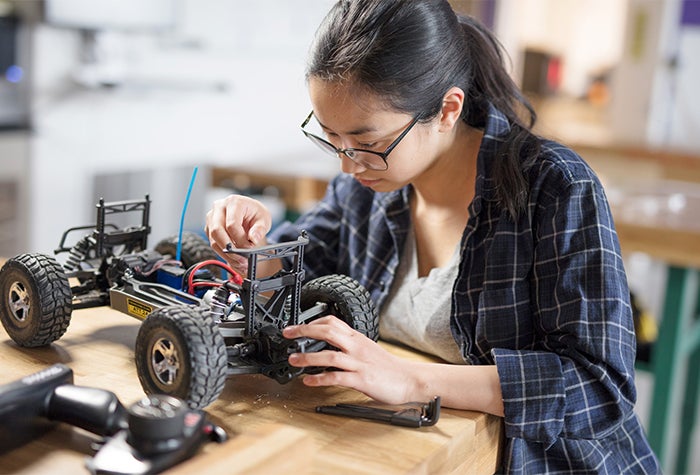 student working on building small car