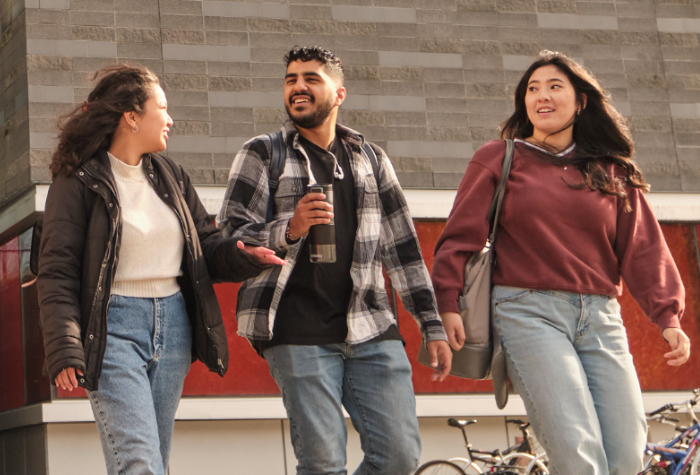 Three students walking on campus