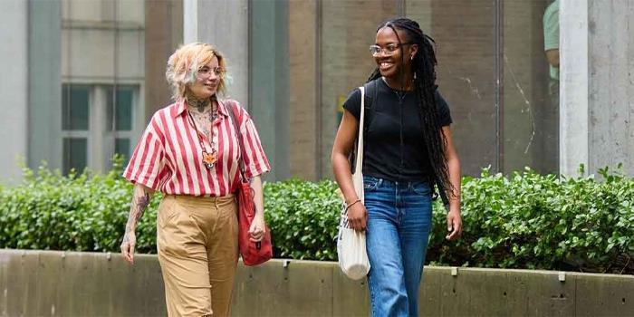 Two students walking together on campus.