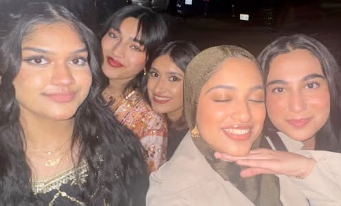 Iman and friends smiling at the camera