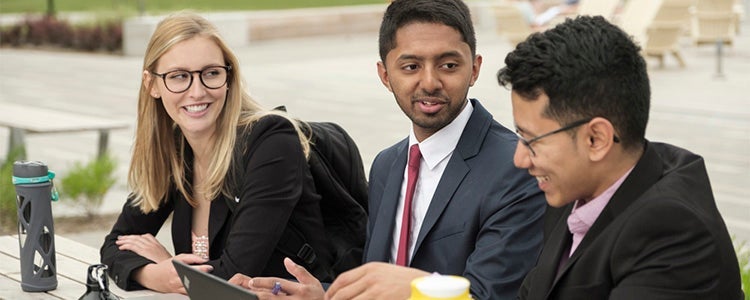 Three finance students talking together