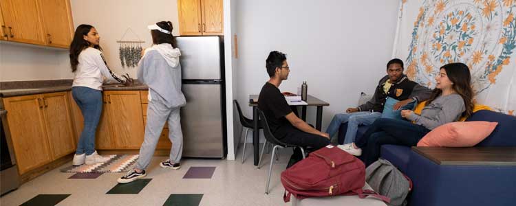 students talking in residence kitchen