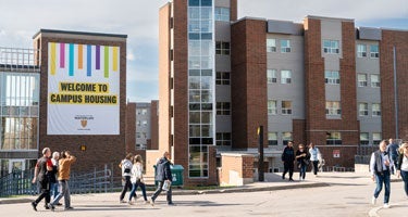 Groups of students walking outside Mackenzie King Village