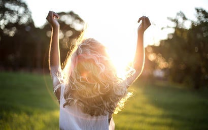 Girl dancing in sunlight.