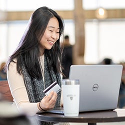 Student at desk using laptop