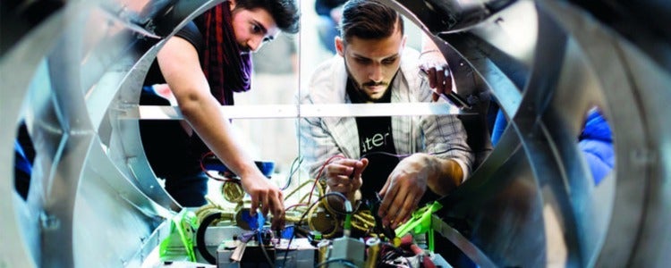 Students working in the design centre on a vehicle.