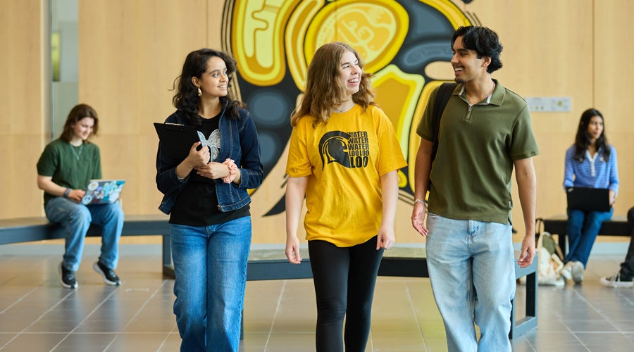 Students talking and walking toward camera