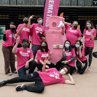 group of math students wearing pink with pink tie mascot