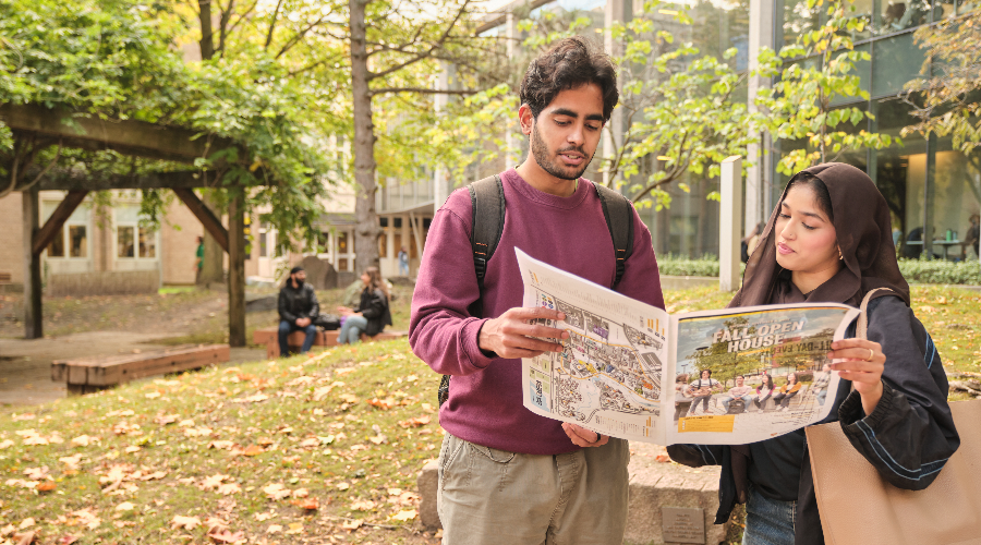 Two students look at a map outside