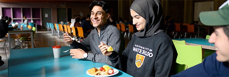 Students sitting in a residence eatery having breakfast
