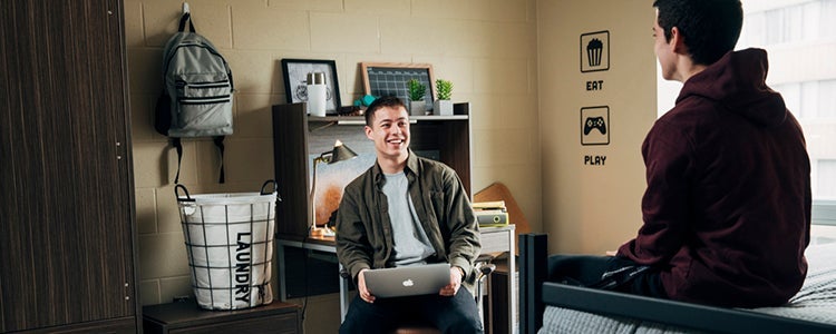 Student and residence don talking together