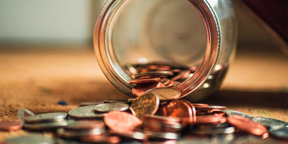 Coins spilling out of a jar.