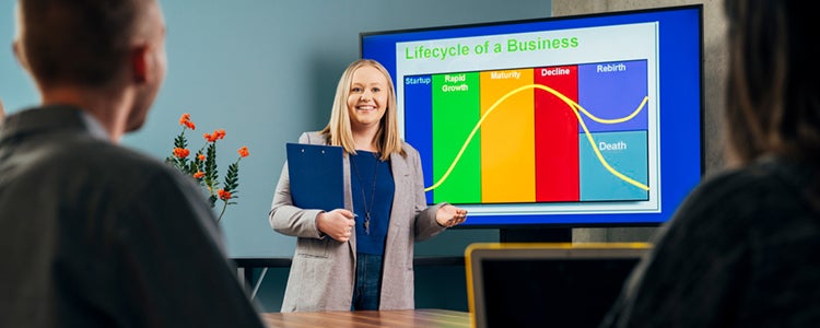 a women presenting a colourful graph to a small group