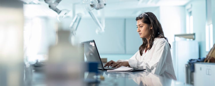 A student in the science and business degree program works in a lab.