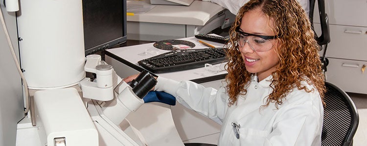 Science student looking at microscope