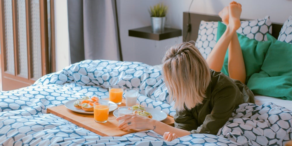 Girl in a condo bedroom.