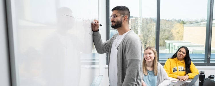 Student writing on a whiteboard