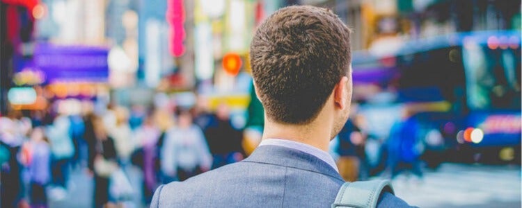 Man in a suit in an urban centre.