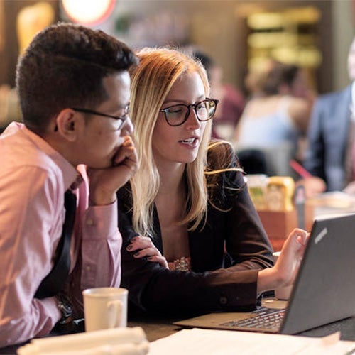 2 students using laptop