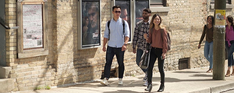 Students walking by Princess Cinemas in Waterloo, Ontario