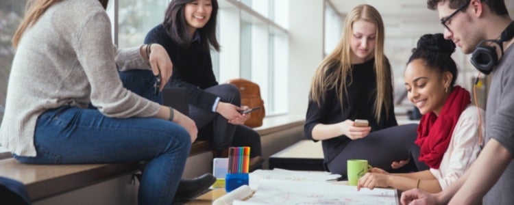 Five students work on a project together in the Planning Design Studio, located in the Environment 3 building