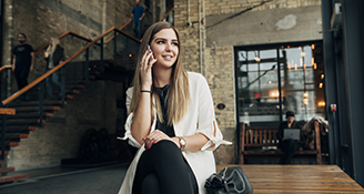 A student holds a phone to her ear