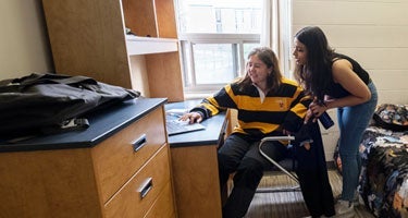 Students in a room in a suite-style residence