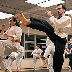 A member of the Tae Kwon Do club does a kick during practice