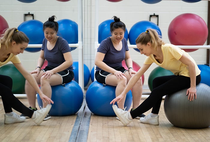Students stretching with exercise balls
